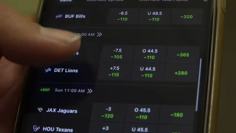 Active BD sports fan monitoring live statistics on multiple devices during a key cricket match